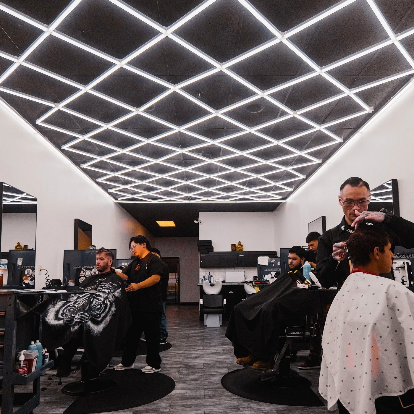 A full row of chairs during a busy shift at Kongo Barbershop